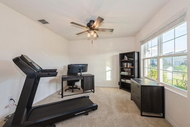 workout room featuring light colored carpet and ceiling fan