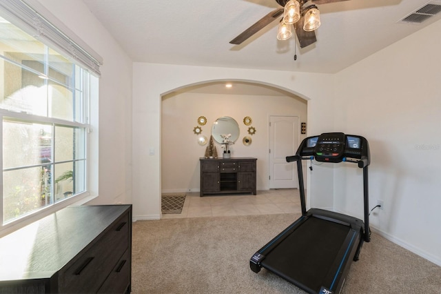 exercise area with light carpet, plenty of natural light, and ceiling fan