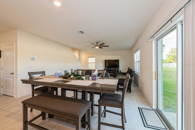 tiled dining area with ceiling fan