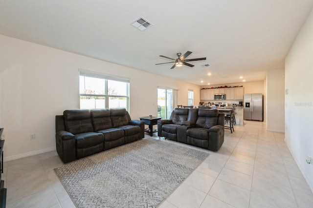 living room featuring ceiling fan and light tile patterned flooring