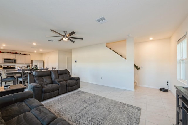 tiled living room with ceiling fan