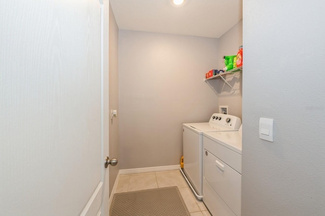 clothes washing area with light tile patterned floors and separate washer and dryer