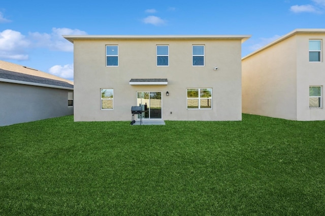 rear view of property with a yard