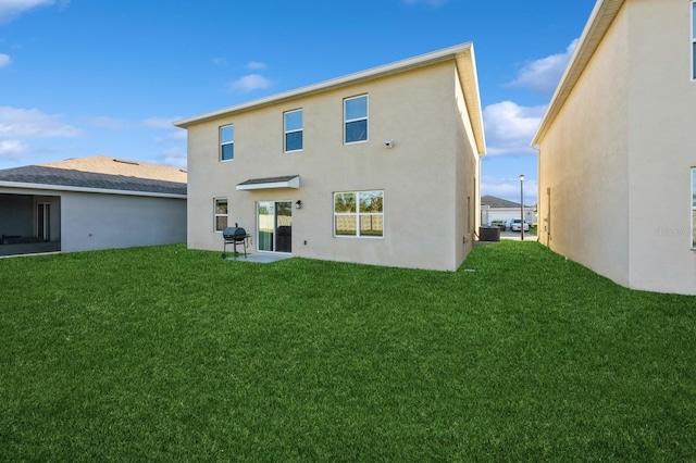 rear view of house with a lawn