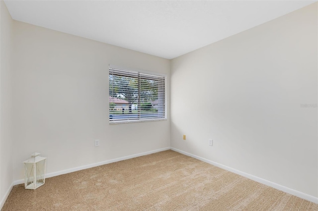 unfurnished room with light carpet