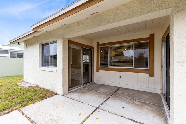 entrance to property featuring a patio