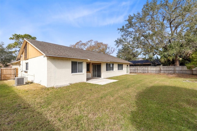 rear view of house featuring a patio area, cooling unit, and a yard