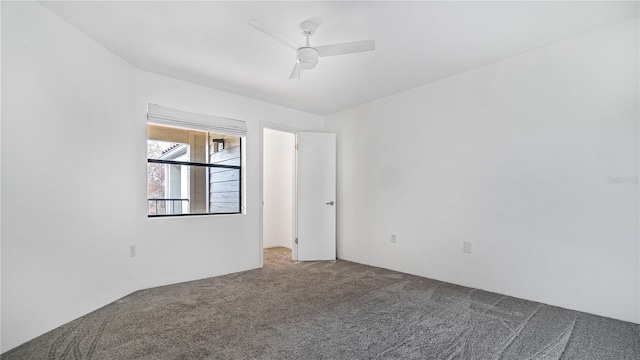 carpeted spare room featuring ceiling fan