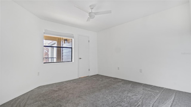 carpeted empty room featuring ceiling fan