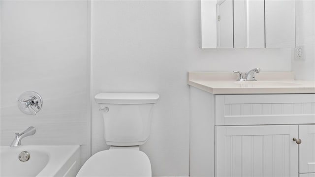 bathroom featuring vanity, a bathtub, and toilet