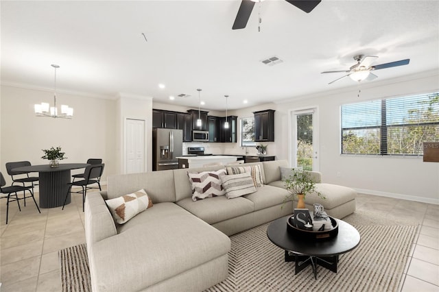 living room with light tile patterned flooring, ceiling fan with notable chandelier, and ornamental molding