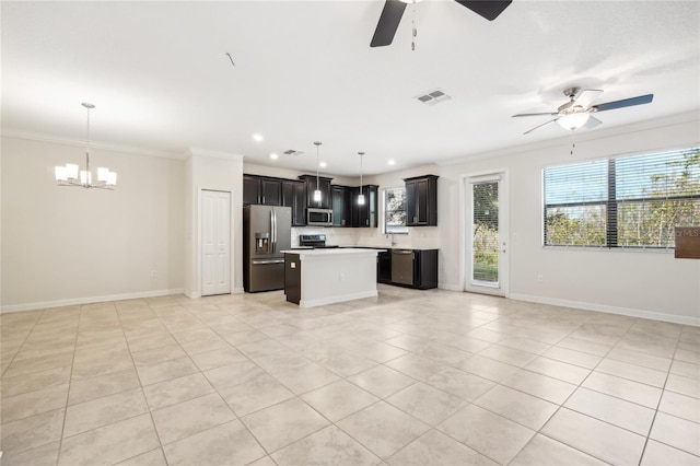 kitchen featuring ceiling fan with notable chandelier, pendant lighting, a center island, and stainless steel appliances