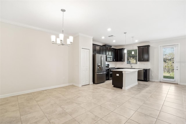 kitchen featuring appliances with stainless steel finishes, light tile patterned floors, a kitchen island, and hanging light fixtures