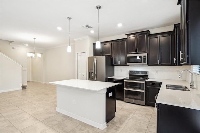 kitchen with a center island, sink, stainless steel appliances, decorative light fixtures, and light tile patterned flooring