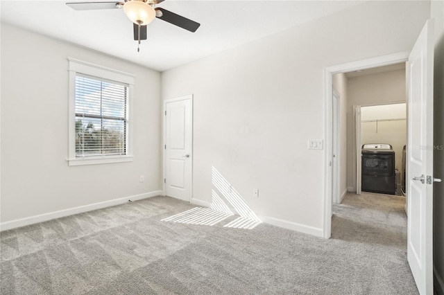 carpeted empty room featuring washer / clothes dryer and ceiling fan