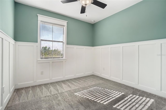 unfurnished room with carpet flooring and ceiling fan