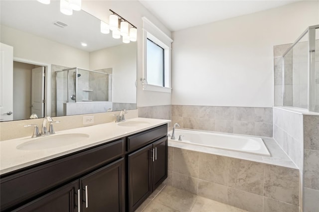 bathroom featuring tile patterned flooring, vanity, and shower with separate bathtub