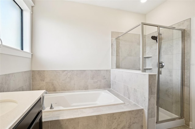 bathroom featuring vanity and separate shower and tub