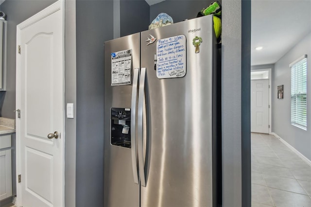 room details with stainless steel fridge with ice dispenser and gray cabinetry