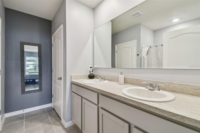 bathroom with tile patterned floors and vanity