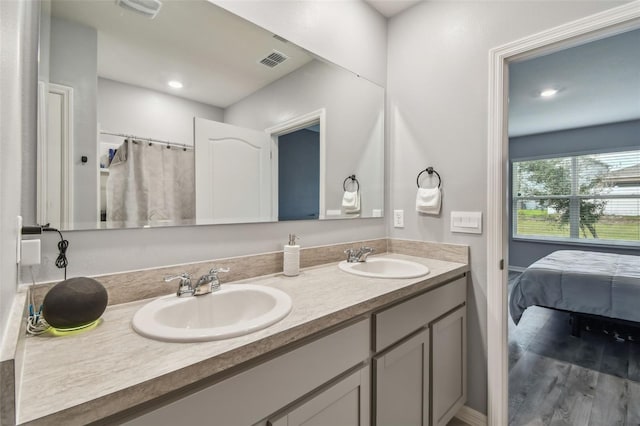 bathroom with a shower with curtain, vanity, and hardwood / wood-style flooring