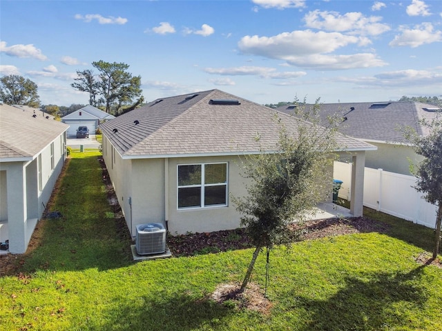 back of property featuring a yard, central AC, and a patio area