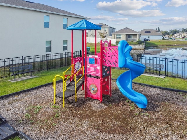 view of play area with a lawn and a water view