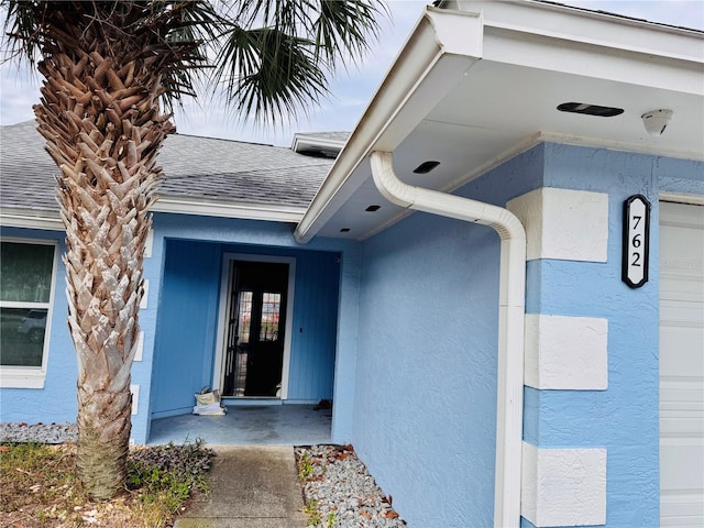 doorway to property featuring a garage