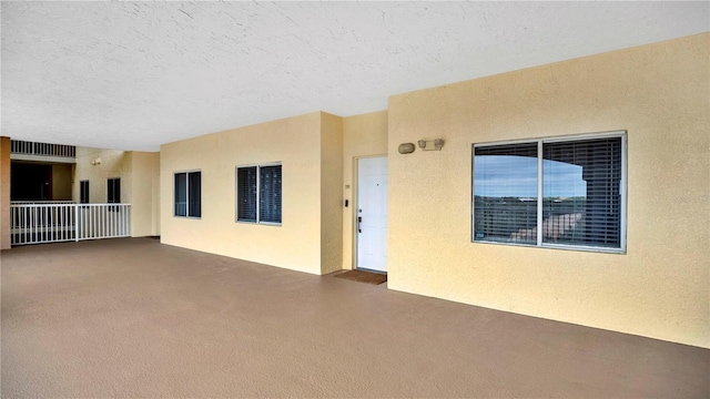 doorway to property with stucco siding