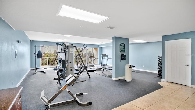 exercise room featuring visible vents and baseboards