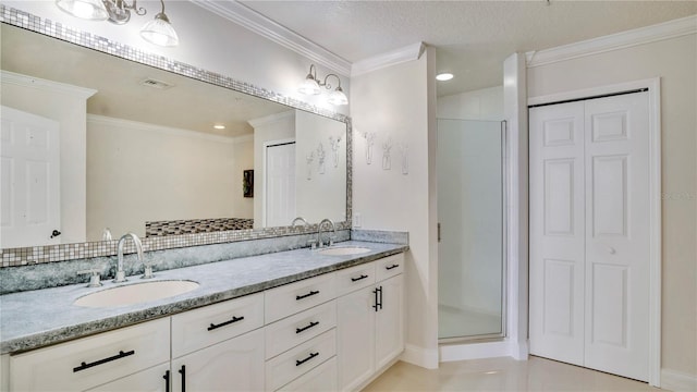 bathroom with ornamental molding, a closet, and a sink