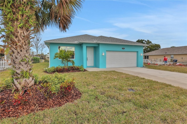 view of front of property with a front lawn and a garage