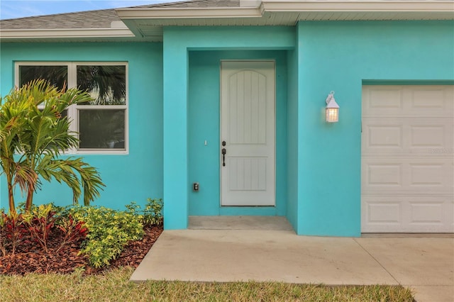 view of exterior entry with a garage