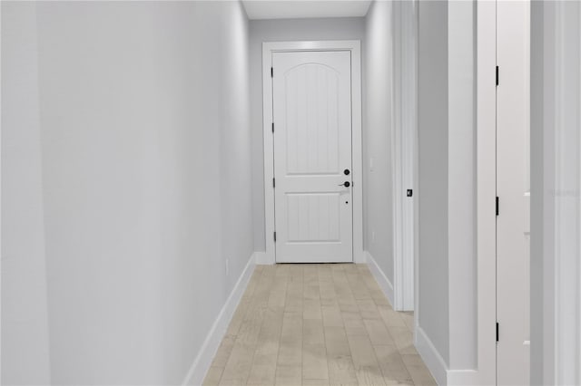 corridor with light hardwood / wood-style flooring