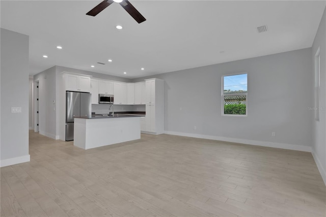 unfurnished living room with light hardwood / wood-style floors and ceiling fan