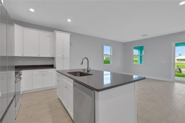 kitchen with dishwasher, white cabinets, plenty of natural light, and sink