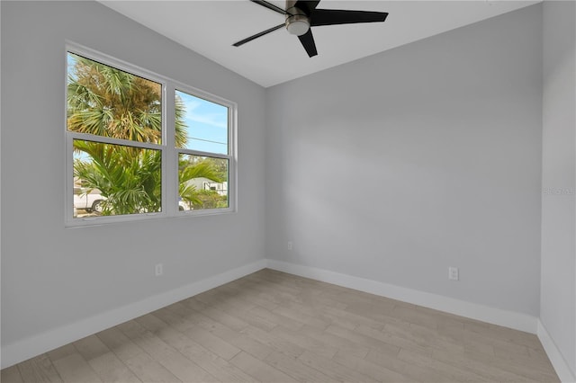 empty room with ceiling fan and light wood-type flooring