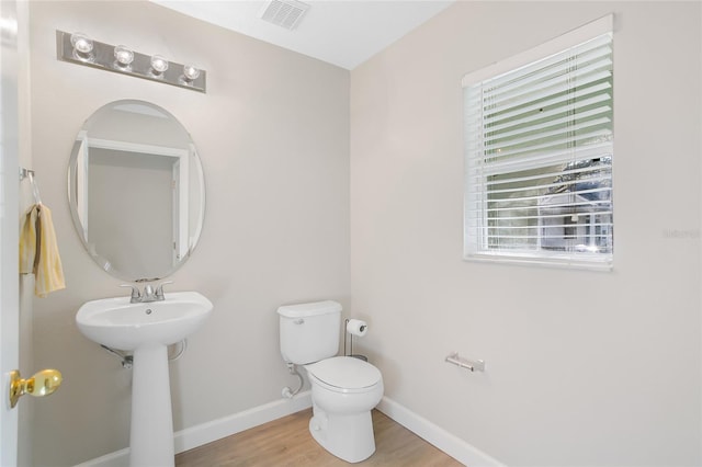 bathroom with wood-type flooring and toilet