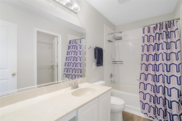 full bathroom with shower / bath combination with curtain, vanity, wood-type flooring, and toilet