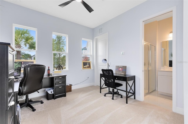 office space with ceiling fan and light carpet