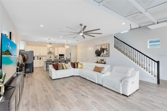 living room with ceiling fan and light hardwood / wood-style floors