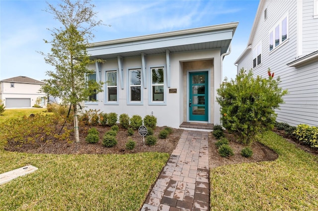 doorway to property with a yard