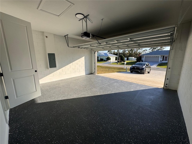 garage featuring electric panel, a garage door opener, and a carport