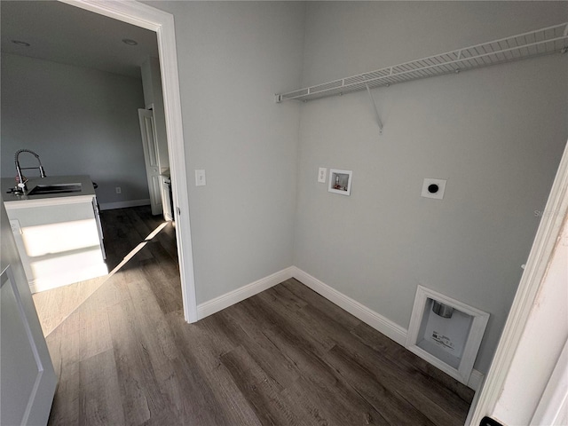 laundry room featuring hookup for a washing machine, sink, and dark wood-type flooring