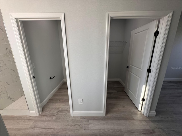 corridor with light hardwood / wood-style floors