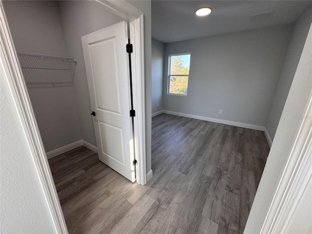 hall with wood-type flooring