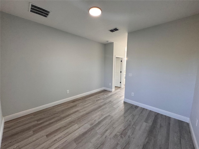 unfurnished room featuring hardwood / wood-style flooring