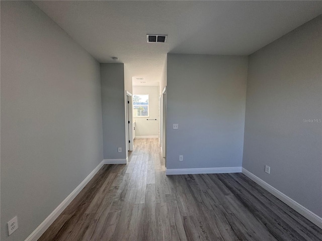 unfurnished room featuring dark hardwood / wood-style flooring