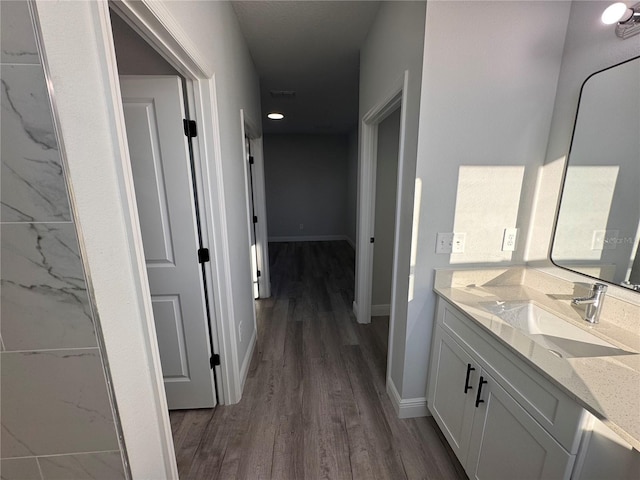 bathroom with hardwood / wood-style floors and vanity