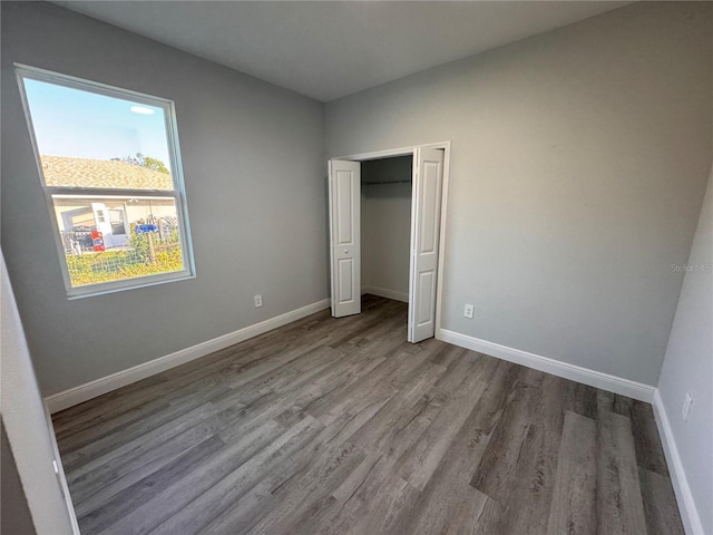 unfurnished bedroom featuring light hardwood / wood-style floors and a closet